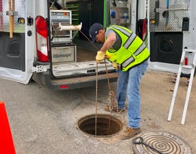 Lowering ROVVER X into Manhole